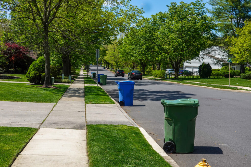 Garbage bins out on the curb of a neighborhood